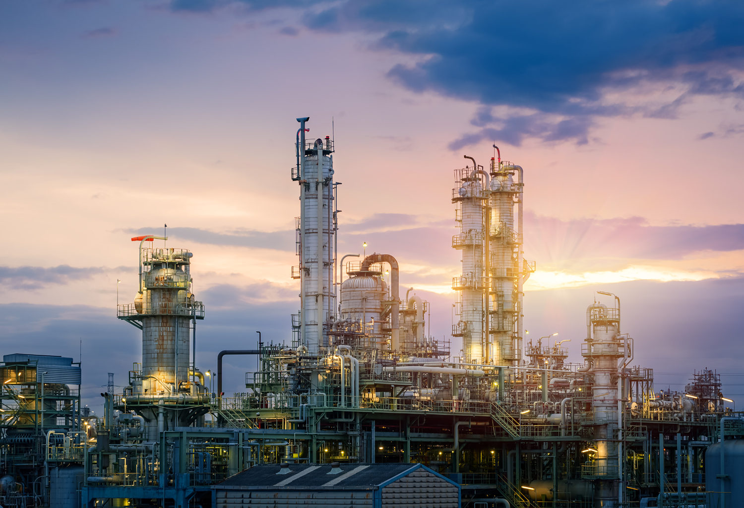 Oil and gas refinery plan or petrochemical industry on sky sunset background, Factory at evening, Manufacturing of petroleum industrial plant.